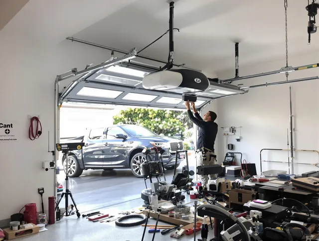 Plymouth Garage Door Repair specialist installing smart garage door opener system in Plymouth home